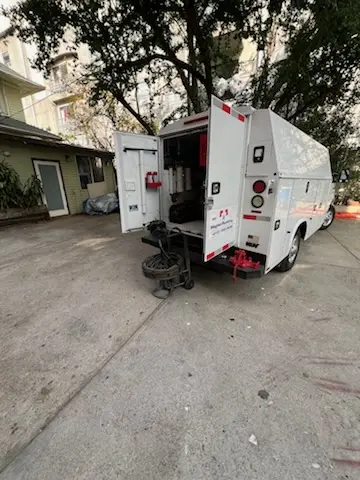 Magnet Plumbing service vehicle on-site for Grease Trap Cleaning in Bufflao Manor